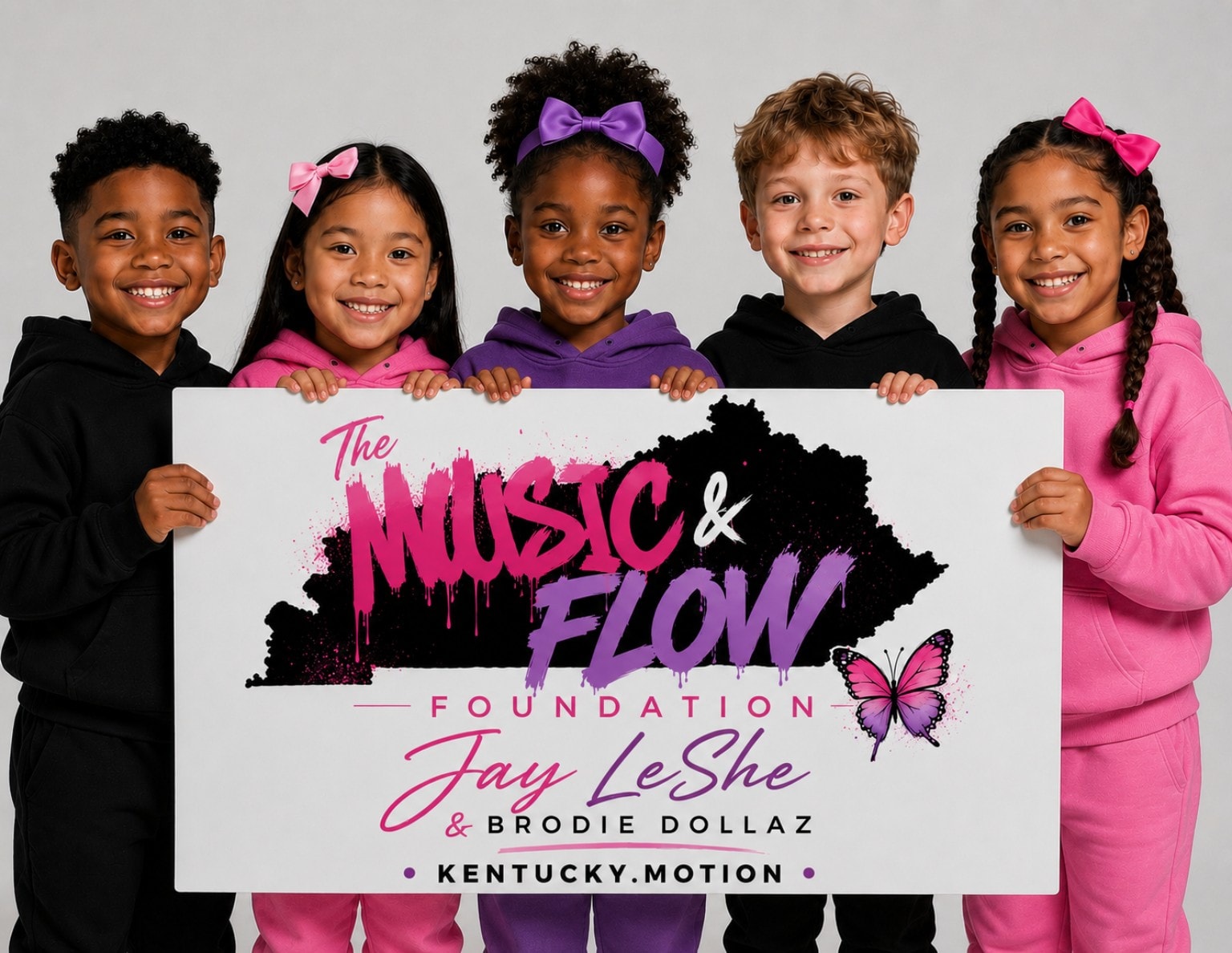 Five children smiling and holding The Music & Flow Foundation banner by Jay LeShe and Brodie Dollaz