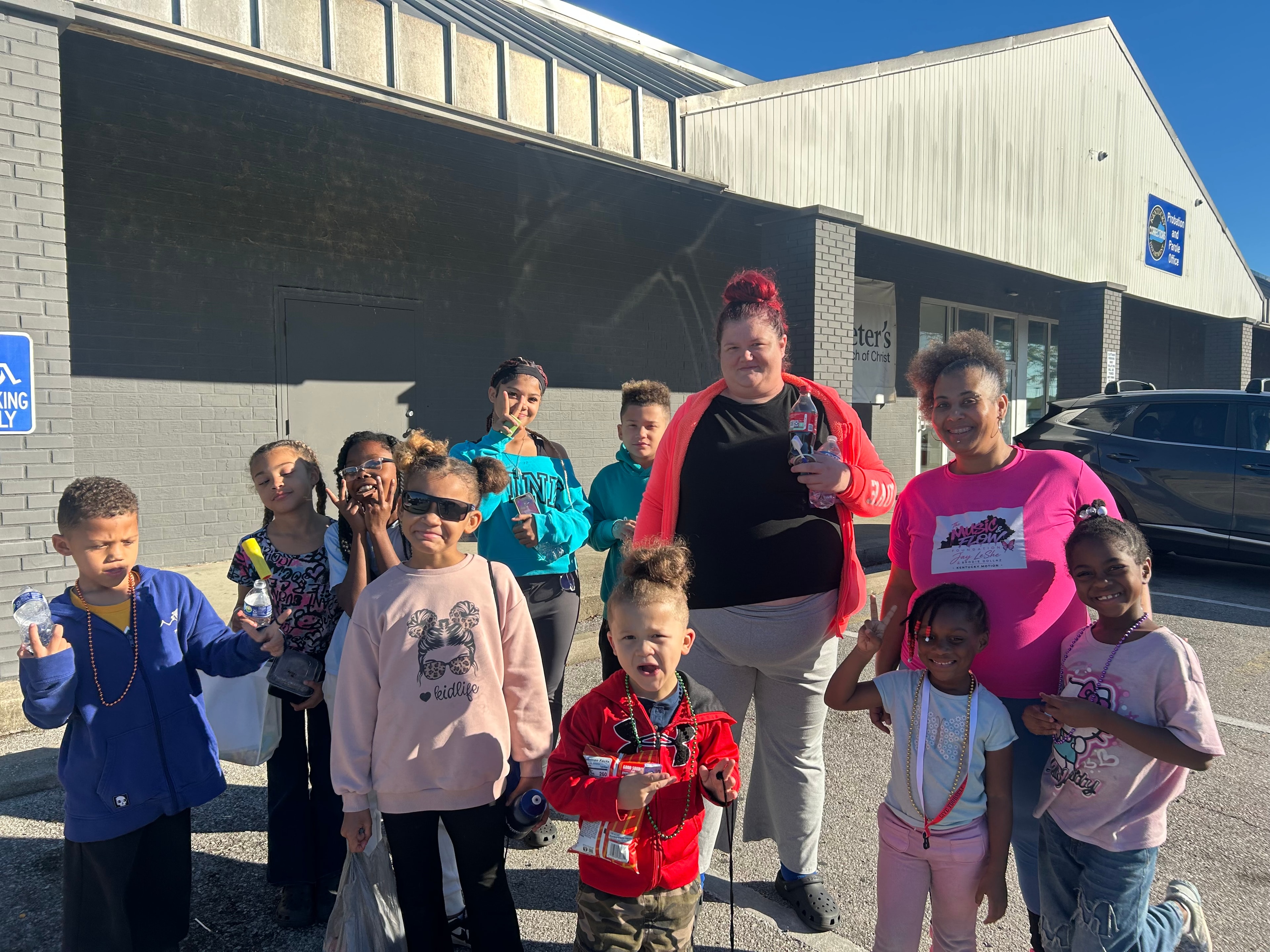 Large group of children and adults posing outside St. Peter United Church of Christ at Operation Warm Hearts