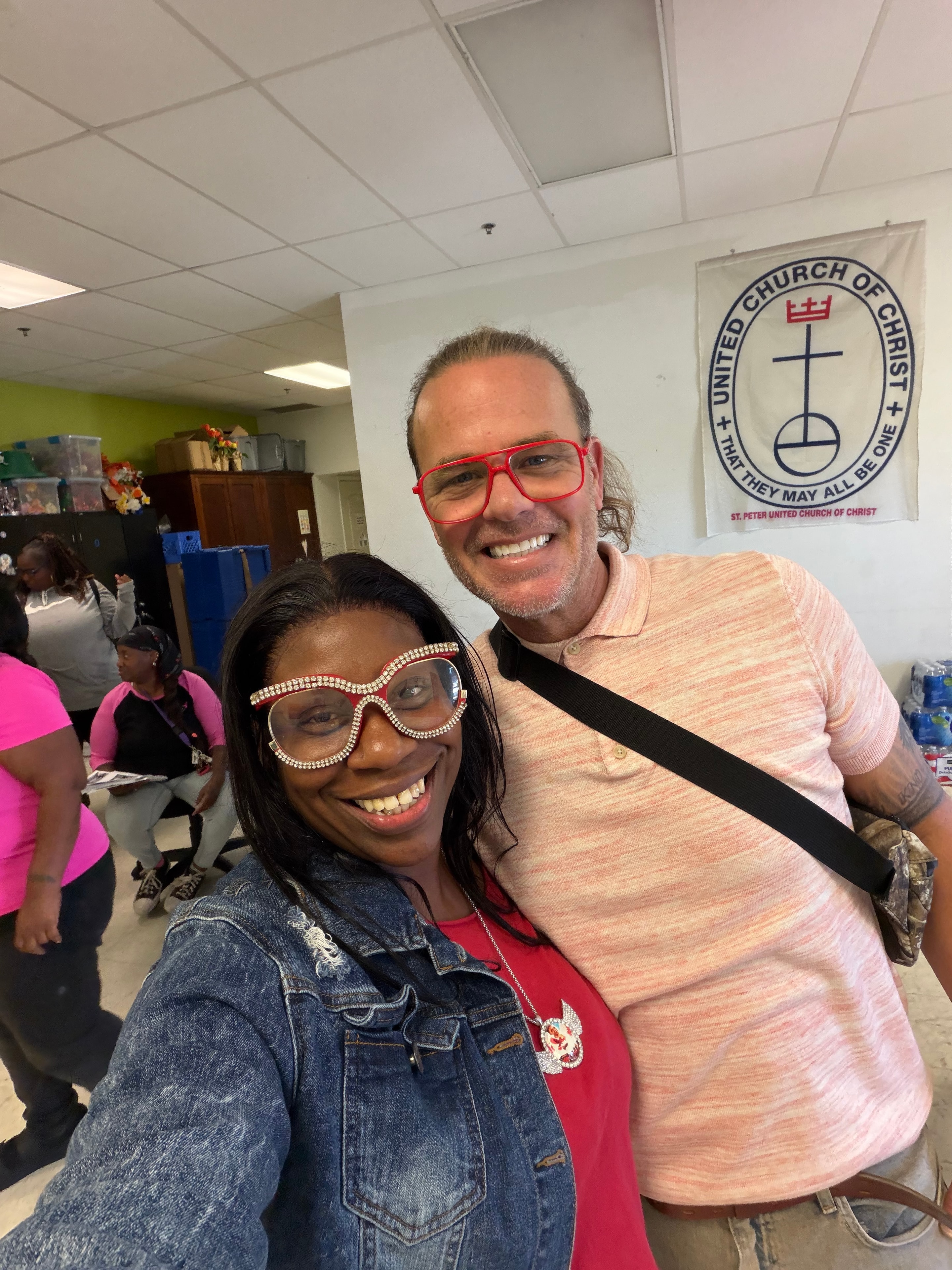 Two people smiling together inside St. Peter United Church of Christ at Operation Warm Hearts
