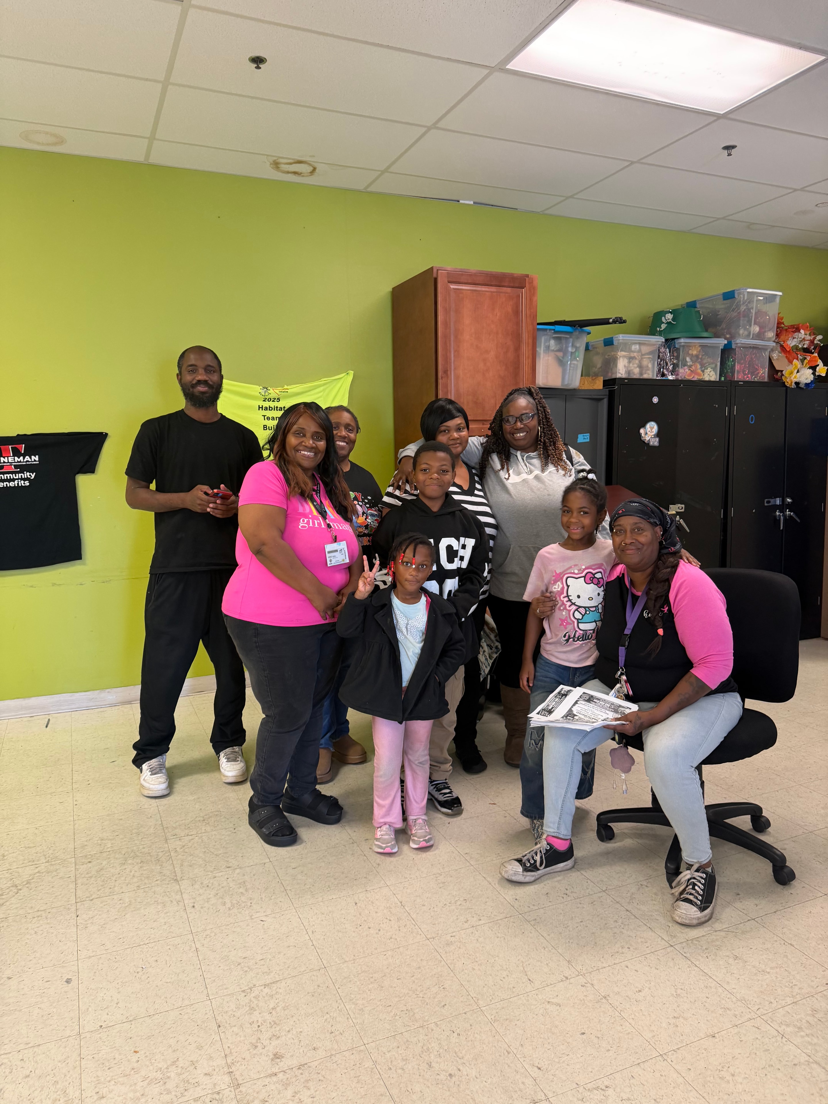 Group of children and volunteers posing together at Operation Warm Hearts